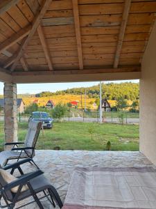 a rocking chair on a patio with a view of a yard at Gabriels7 in Korita