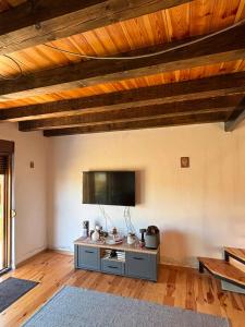 a living room with a flat screen tv on the wall at Gabriels7 in Korita
