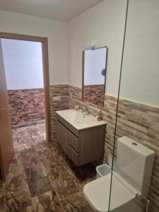 a bathroom with a sink and a shower and a toilet at Luz del Mar in Órzola