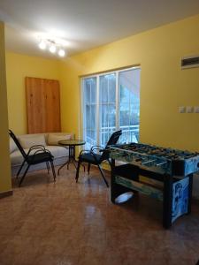 a living room with a table and chairs and a couch at Drina Lake House in Zvornik