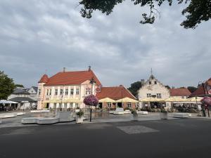 a group of buildings in a town with a street at Kuressaare kesklinn, Turu Apartment in Kuressaare