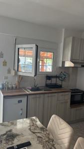 a kitchen with a sink and a counter top at Olimpik bic in Paralia Katerinis