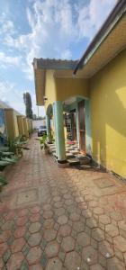 a house with a brick walkway in front of it at Tarakea Lodge in Mbuguni