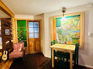 a room with a table and a map on the wall at Treehouse Patagonia in Puerto Natales