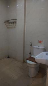 a bathroom with a toilet and a sink at The Cabin Hotel Ngupasan in Yogyakarta +19 photos