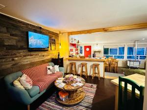 a living room with a couch and a table at Treehouse Patagonia in Puerto Natales