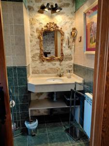 a bathroom with a sink and a mirror at CASA RURAL SANDRA in La Carrera +37 photos
