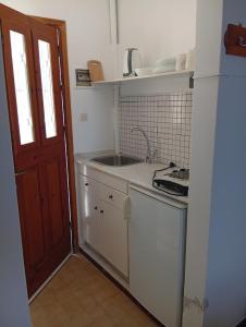 a small kitchen with a sink and a door at Sevi - Irene Studios in Masouri