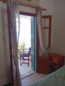 a bedroom with a door open to a patio at Sevi - Irene Studios in Masouri