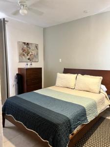 a bedroom with a large bed and a dresser at Hotel Rinconda del Arcangel in Tepoztlán