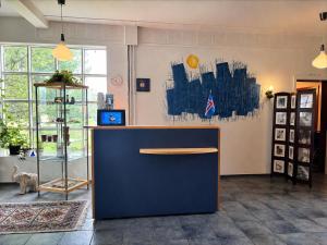 a lobby with a blue counter in a room at Hotel Stadarborg in Breiðdalsvík