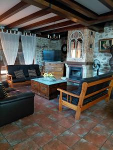 a living room with a couch and a fireplace at CASA RURAL SANDRA in La Carrera