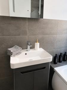 a bathroom with a white sink and a mirror at Queenie's Nook in North Shields +8 photos