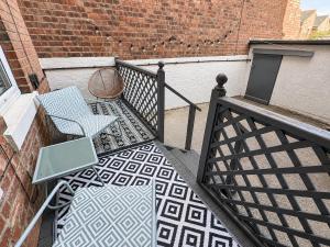 a balcony with a table and a laptop on it at Queenie's Nook in North Shields