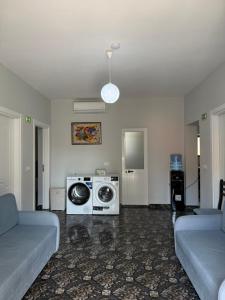 a living room with a washing machine and a couch at Rezidenca Inspire in Tirana