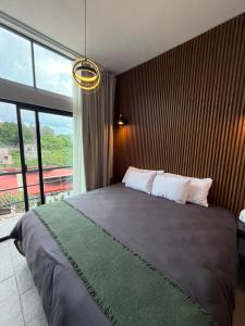 a bedroom with a large bed with a large window at Casona San Cayetano Suites & Lofts & Spa by SCE in Guanajuato +279 photos