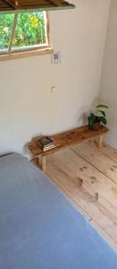 a bedroom with a bed and a table with a plant at FOLHA HOUSE Experience in Paraty