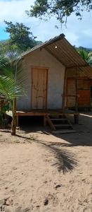 a small shack with a door on the side of it at FOLHA HOUSE Experience in Paraty