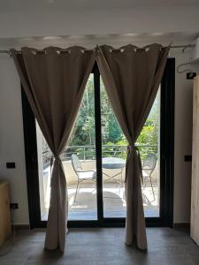 a pair of curtains in front of a sliding glass door at Lungomare private rooms in Vlorë +9 photos