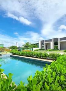 a swimming pool in front of a house at Casa Aquiraz in Aquiraz