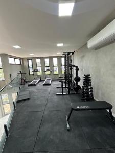 a gym with several treadmills and machines in a room at Casa Aquiraz in Aquiraz
