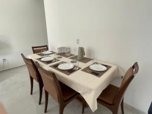 a table with chairs and a table cloth on it at Casa Aquiraz in Aquiraz