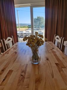 a vase of flowers sitting on top of a wooden table at Villa Jopi in Neum