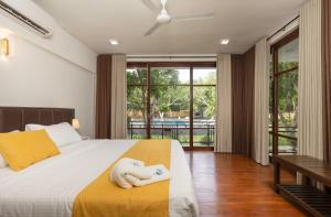 a bedroom with a bed with a towel on it at Villa Oasis in Kataragama +24 photos