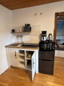 a small kitchen with a sink and a stove at Fewo kleine Auszeit in Karbach