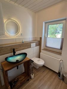 a bathroom with a blue sink and a toilet at Fewo kleine Auszeit in Karbach