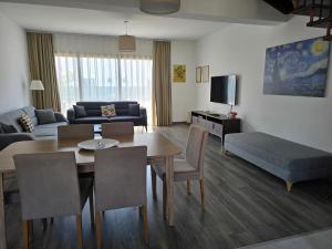 a living room with a table and a couch at Villa West Park, Kyrenia in Kyrenia