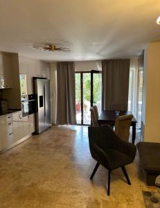 a kitchen and living room with a table and chairs at Sofia Villa in Astris