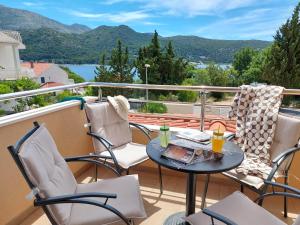 a patio with a table and chairs on a balcony at Slano Bay Apartments in Slano