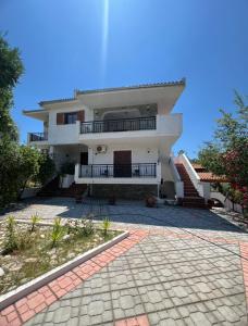 a large white house with a balcony and a driveway at Sofia Villa in Astris