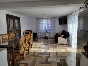 a kitchen and dining room with a table and chairs at Casa Luci&Matei in Căciulata