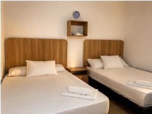 two beds sitting next to each other in a room at Hostal Monte Verde in Zaragoza +18 photos