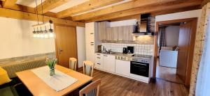 a kitchen with a table and a dining room at Schattaugut in Eben im Pongau