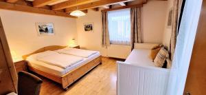 a bedroom with two beds and a window at Schattaugut in Eben im Pongau +40 photos