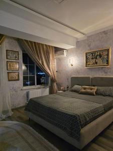 a bedroom with a large bed and a window at Apartment with FREE Massage chair Fergana in Fergana