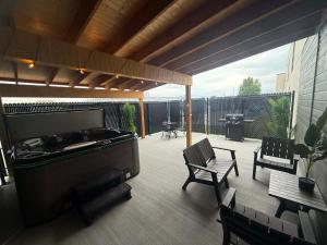 a covered patio with a pool table and chairs at Hôtel Le Voyageur in Saint-Georges