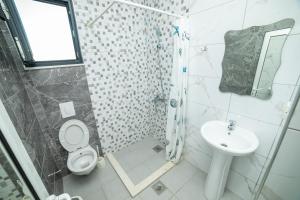 a bathroom with a shower and a toilet and a sink at Apartments IL GUSTO in Ulcinj +58 photos