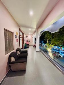 a living room with a couch and a balcony at The Loop Auroville - High-Speed WiFi & Free Parking, Near Auroville Bakery & Tanto Pizzeria, 5-Minute Drive to ECR & Auroville Beach in Auroville