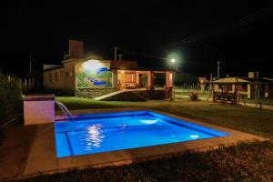 a swimming pool in front of a house at night at Marta Maria in El Rodeo