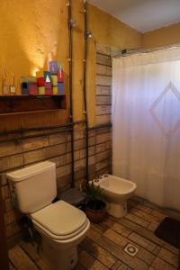 a bathroom with a toilet and a sink at Marta Maria in El Rodeo +7 photos