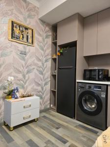 a kitchen with a refrigerator and a washing machine at Apartment with FREE Massage chair Fergana in Fergana