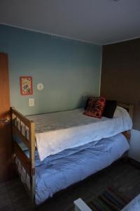 a bed in a bedroom with a blue wall at Marta Maria in El Rodeo