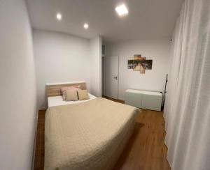 a bedroom with a bed in a white room at Apartmán Kutička in Prešov