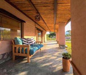 a porch with a blue couch on a building at Marta Maria in El Rodeo