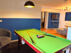 a room with a pool table in a living room at Hotel Orange Kutaisi in Kutaisi +90 photos