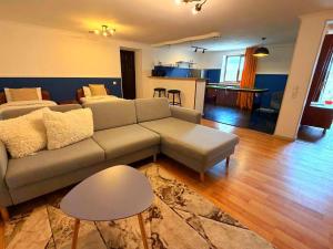 a living room with a couch and a kitchen at Hotel Orange Kutaisi in Kutaisi
